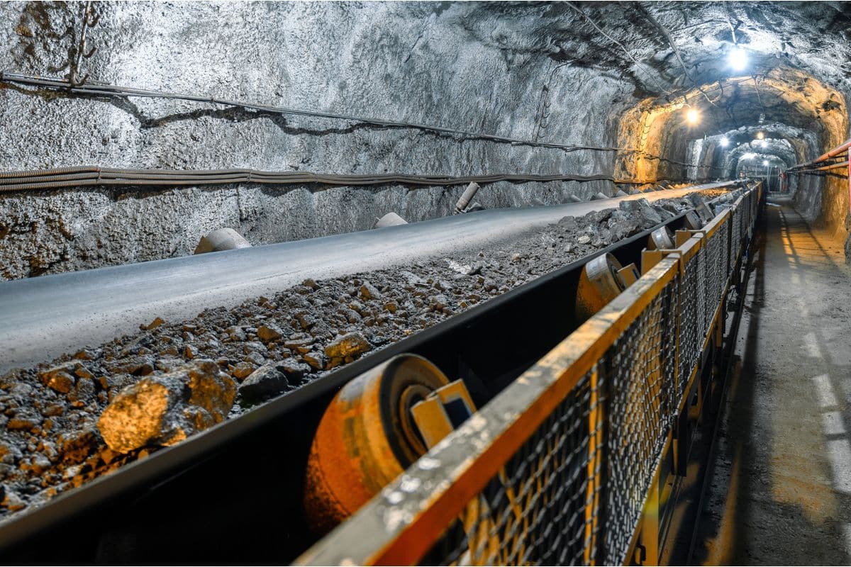 Belt conveyor in an underground tunnel. Transportation of ore to the surface.